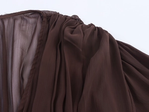 Detail of pleated dark brown chiffon shoulder with elegant texture and sheer fabric