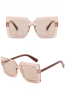Detail view of large square tea-colored sunglasses showing both front and side profiles