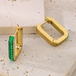Golden geometric earrings with green rectangular rhinestones on white stone base