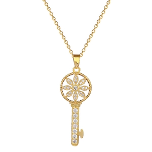 Luxurious gold starburst key pendant necklace with sparkling pavé crystals on a white background