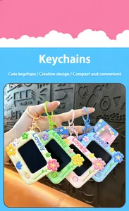 Four colorful mini flower LCD drawing board keychains held in hand with lovely details.