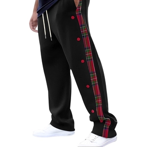 Men's straight casual pants in black with red and green plaid side stripe and buttons