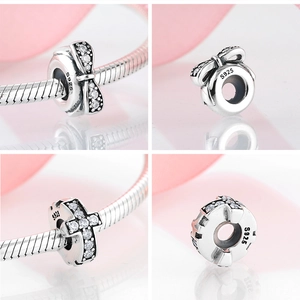 Close-up of S925 sterling silver bow and cross spacer charms with clear zircon stones