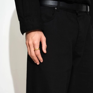 Close-up of minimalist 18k gold plated stainless steel ring worn on a model's finger