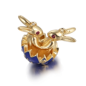 Detail of golden double bunny pendants in blue enamel eggshell with red gem eyes
