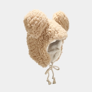Cute lamb wool winter hat with bear ears and earflaps in warm khaki color