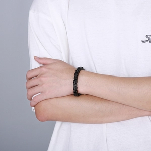 Close-up of black titanium steel curb chain bracelet on wrist with industrial link detail