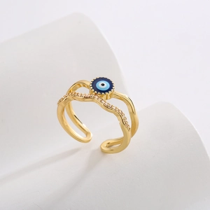 Close-up of golden double-layer ring with evil eye enamel and zircon pavé detail