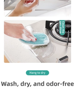 Detail of dual-sided kitchen sponge cleaning grease from a gas stove and sink