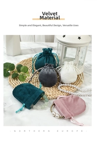 Detail view of colorful velvet drawstring pouches for jewelry storage on woven mat