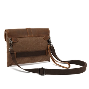 Vintage dark brown canvas and leather men's crossbody bag with adjustable strap on white background