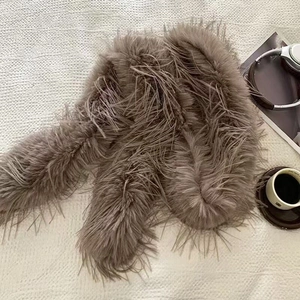 Detailed view of the soft taupe feather texture on a luxury plush winter scarf