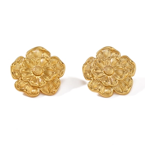 Elegant gold flower stud earrings with textured petals and intricate stamen details