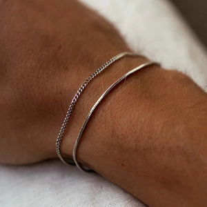 Double-layered silver curb and snake chain bracelet set for men on wrist