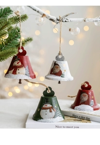 Close-up of metal Christmas bells featuring Santa and Snowman designs with rustic jute loops