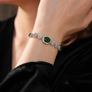 Detailed view of vintage silver flower bracelet with emerald zircon and tiny white diamonds