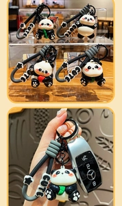 Detail of cute UV plated panda keychain with silicone strap and black metal ring