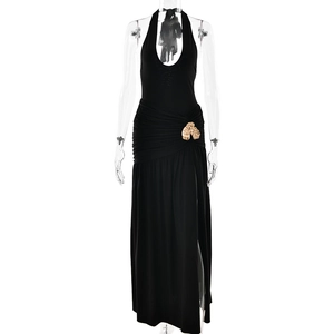 Elegant black halter dress with gold waist chain and high slit for a sexy summer outfit