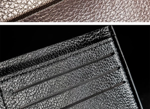 Macro detail of black and brown lychee grain faux leather texture on short men's wallet