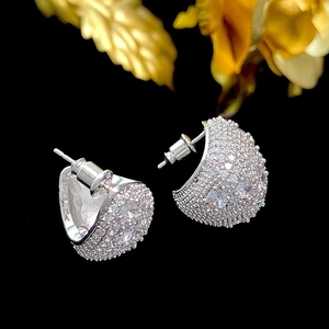 Silver teardrop C-shaped stud earrings with micro-paved zircons on black background