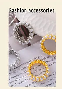 Detailed macro view of pearl-embellished round ring jewelry in gold and silver finish