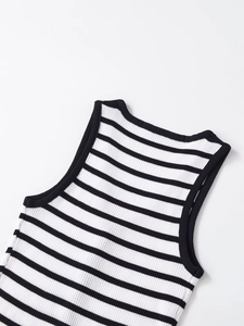 Detail of V-neck and ribbed texture on the black and white striped knit vest