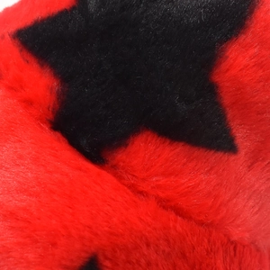 Close-up of soft red faux fur texture featuring a black star pattern for winter warmth