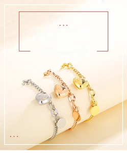 Detailed view of heart-shaped charm bracelets in silver, gold and rose gold finishes