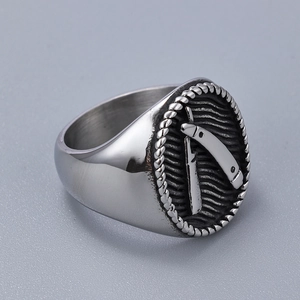 Macro view of vintage silver steel ring featuring a 3D straight razor relief design