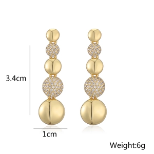 Detailed view of 18K gold drop earrings showing 3.4cm length and zircon disk details
