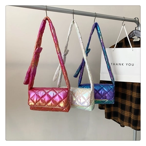 Three quilted crossbody bags in iridescent pink, white, and purple gradient finishes