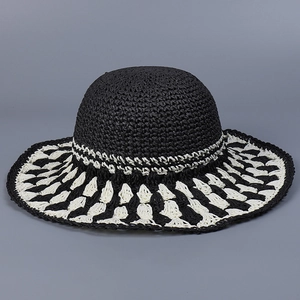 Detailed view of the handcrafted crochet texture on a wide-brim black and white sun hat