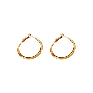 Minimalist twisted gold hoop earrings with unique dual-texture polished and hammered finish