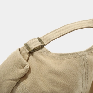 Close-up of khaki cotton docker hat back showing brass buckle and double stitching detail