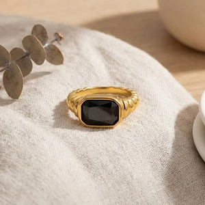 Detail of French vintage twisted gold ring featuring a large rectangular black gemstone