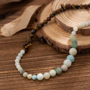 Natural tiger eye and amazonite beaded necklace for men on rustic wood background