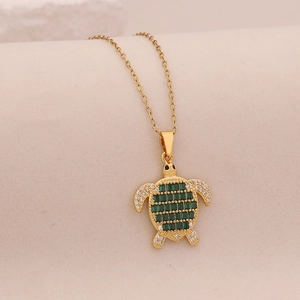 Golden turtle pendant necklace with green cubic zirconia and sparkling crystals