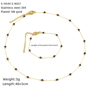 Detailed view of 18K gold plated stainless steel jewelry set with black stone beads