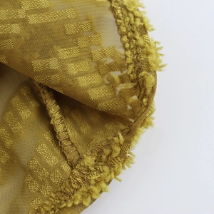 Textured V-neck lantern sleeve shirt in mustard yellow mesh fabric with fringed details