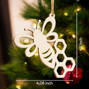 Detail view of the wooden bee and honeycomb ornament showing dimensions of 4.5 by 4.08 inches