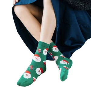 Festive forest green Christmas socks featuring Santa Claus and red gift patterns