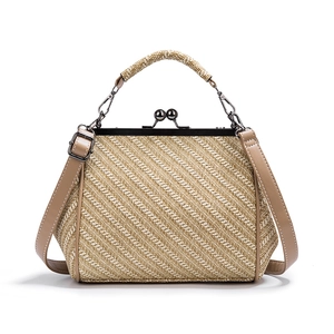 Retro beige woven handbag with brown leather straps and vintage metal frame clasp