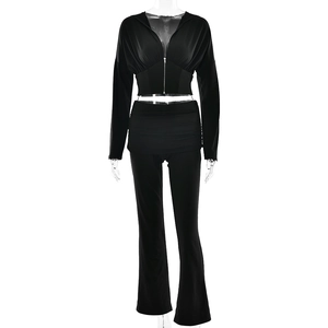 Women's 2-piece black tracksuit featuring zip-up cropped hoodie and flared high-waisted pants