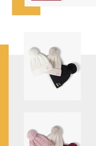Detailed cable knit texture and cherry embroidery on winter hats with large fur pom-poms