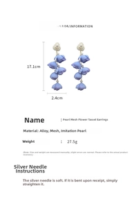 Detail view of long fabric flower tassel earrings with size 17.1x2.4cm and pearl accents