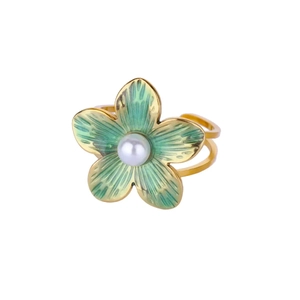 Detailed macro view of a gold flower ring with green enamel petals and a central pearl