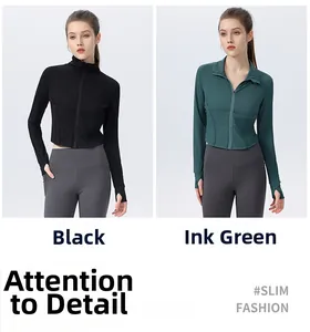 Detail of slim fit sports jacket with thumb holes and high collar zip in black and ink green