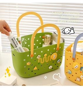 Green portable storage basket with yellow handle holding toiletries and Mino charms
