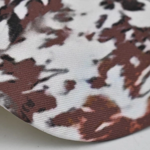 Close-up of the cow print knitted fabric detail on the brim of this baseball cap