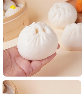 Close-up of realistic white PVC steamed bun model with soft texture on a bamboo steamer
